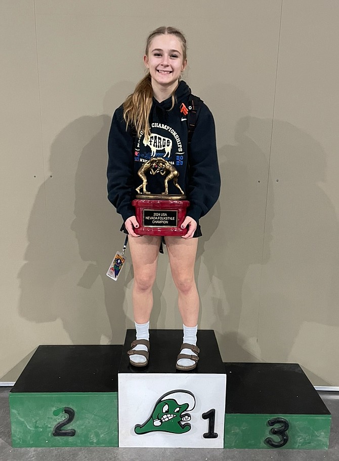 Ella Kavanagh poses for a photo with the championship trophy after winning the 2024 Nevada Folkstyle state championship.