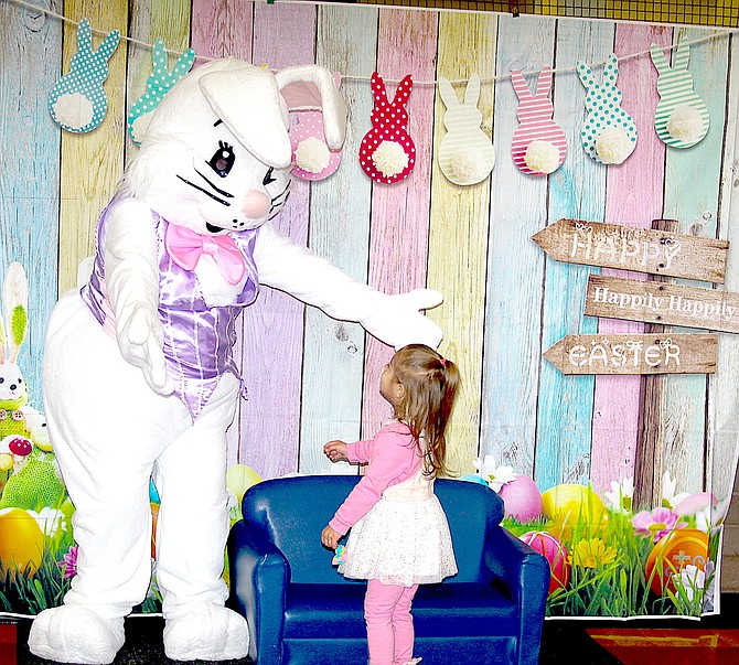 The Easter Bunny greets 2-year-old Umber Toor during the Douglas County Community & Senior Center’s Toddler Time on Thursday.