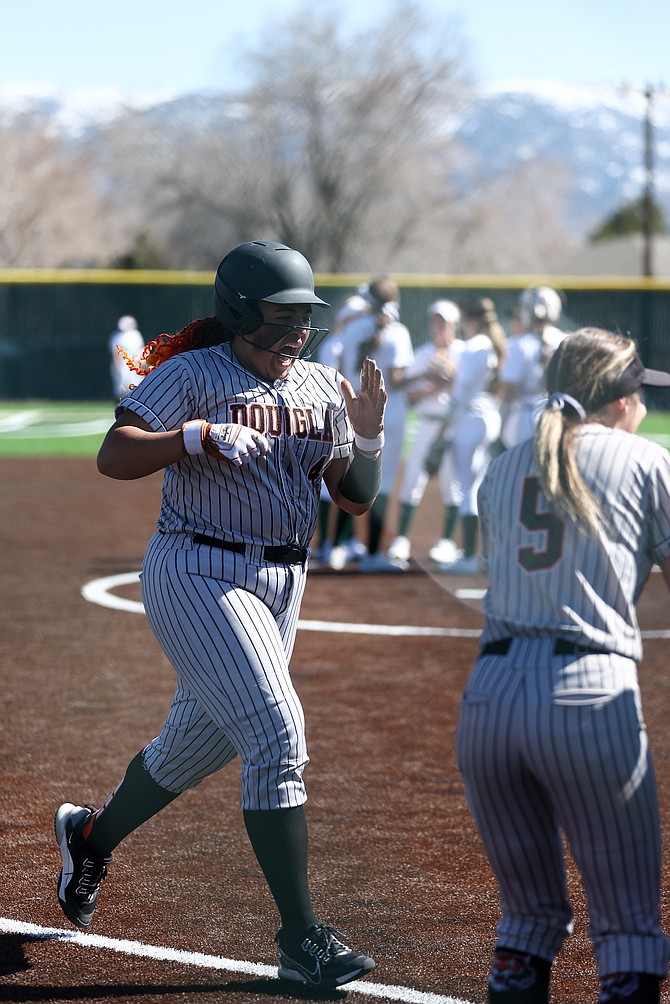 Douglas High senior Lilyann Lee reacts before crossing home plate after hitting one of her six home runs this season. Lee currently leads the state with her six home runs.