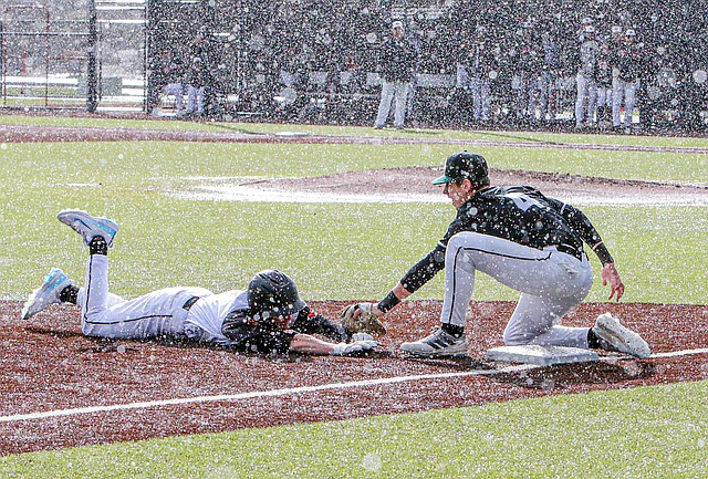 Monroe Bearcat Senior Bryce Niemi slides into the tag at third by Jackson Junior Lucus Poindexter in the Bearcats’ loss 6 - 2 on a wet, wet Wednesday, March 27 in Monroe. The non-conference match was played under heavy rain that ceded to bright sunshine with the occasional rainbow. The game went the regulation 7 innings to a 1 - 1 tie.  Extra innings turned the game into batting practice for the Jackson Timberwolves, which added five runs to the Bearcats’ one.