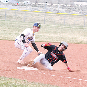 Lowry’s Adam Brooks attempts to tag out a Fernley runner at third base.