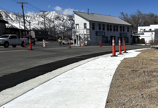 Brand new gutter, curb and sidewalk shines in front of Gardnerville Station on Monday.
