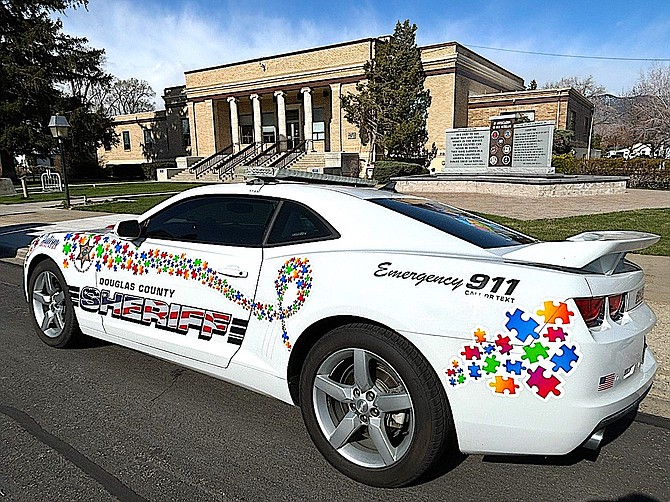 The Douglas County Sheriff’s Office is displaying its annual wrapped vehicle with colorful puzzle pieces for the fifth year in a row.