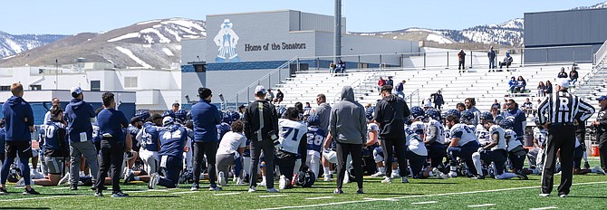 The Nevada football team listens to instructions during Saturday's open scrimmage at Carson High School.