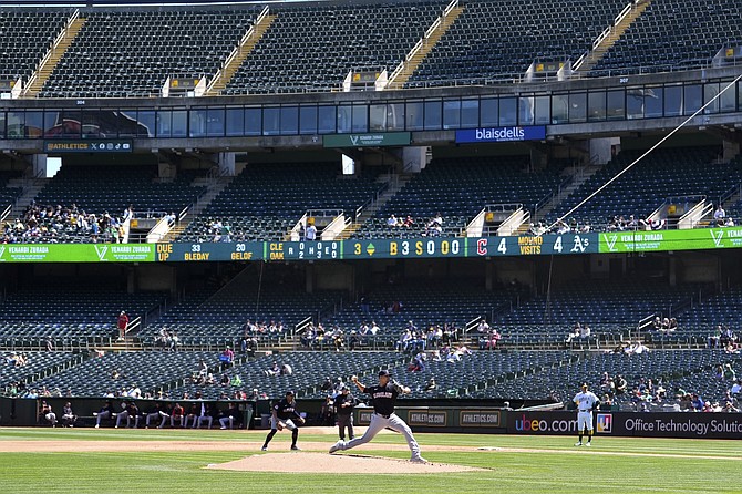 Guardians pitcher Carlos Carrasco works against the Oakland Athletics during the teams’ game on March 31.