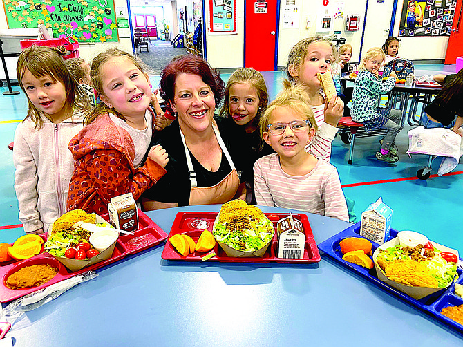 Jacks Valley Nutrition Manager Stacy Chamberlain and some students show off their school lunch. Douglas County School District takes pride in the variety of meals provided for students.