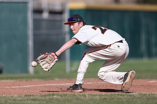 Douglas High third baseman Grayson Kamper makes a backhanded play Tuesday afternoon against Reno.