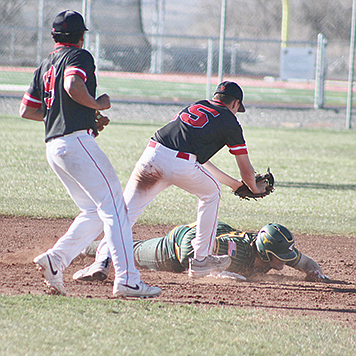 Pershing County’s Tyler Miller tags a Battle Mountain base runner at second base.
