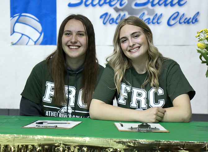 Carson High’s Sarah Miller, left, and Douglas High’s Shasta Garr smile after signing their letter of commitment to play volleyball at Feather River College next year.