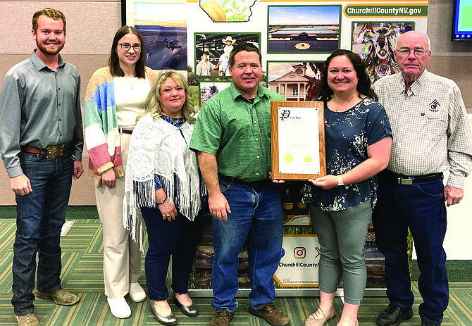Commissioners adopt a proclamation to recognize April as Child Abuse Prevention and Awareness month. From left: Commissioner Justin Heath, Emma Knapp, Jill Manha and Brittany Burton with Commissioners Myles Getto and Bus Scharmann.