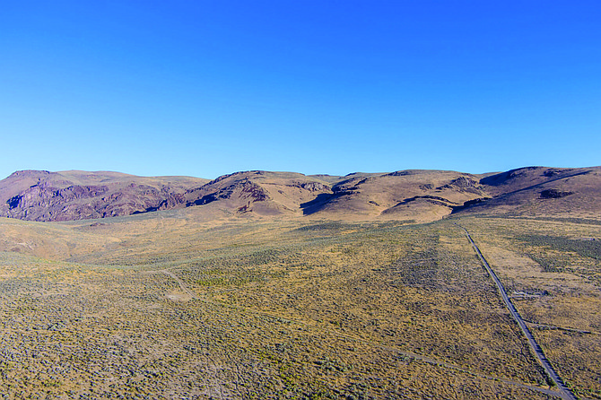 Aerial view of a dirt road leading up through the Thacker Pass Lithium mining area.