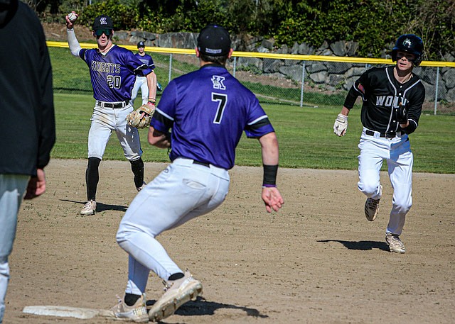 In a classic squeeze, Kamiak junior Elijah Bovey fires the ball to teammate Malachi Noel as Jackson senior Chase Halverson tries for Third during a game April 12 at Jackson’s ballfield. Under a blue sky Jackson beat Kamiak 2 - 0 for the in-conference game.  Jackson’s Drew Pepin pitched the full game, allowing five hits and two walks to shut out the visiting team. Jackson currently leads the 4A baseball conference 3 - 0 (13-1 season overall).