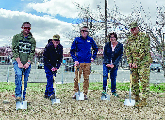 From left: Kyle Pellett, Steve Stewart, retired Chief Warrant Officer Sean Laycox, Christie Pierce and Col. Matt Jonkey, state army aviation officer, participate in a groundbreaking ceremony at the Army Aviation Support Facility north of Reno on April 15 to mark the start of construction of the Mustang 22 Chinook Static Display addition to the Mustang 22 Memorial.