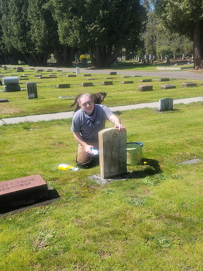 Jay Heike cleans a gravestone at Snohomish’s G.A.R. Cemetery earlier this month.