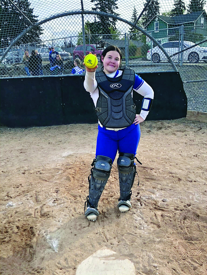 Eatonville' Amy Tozier proudly shows of the ball she hit over the left field fence for her first home run of the season.