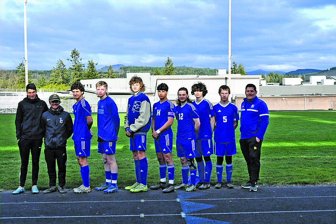 The Eatonville Cruiser senior players pose with their coaches prior to their match against Hoquiam.