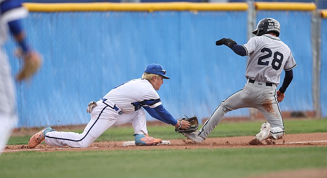 Carson White turns to make a tag at third base against Damonte Ranch Thursday evening. White went 4-for-5 with five RBIs at the plate for Carson in a 13-12 loss.