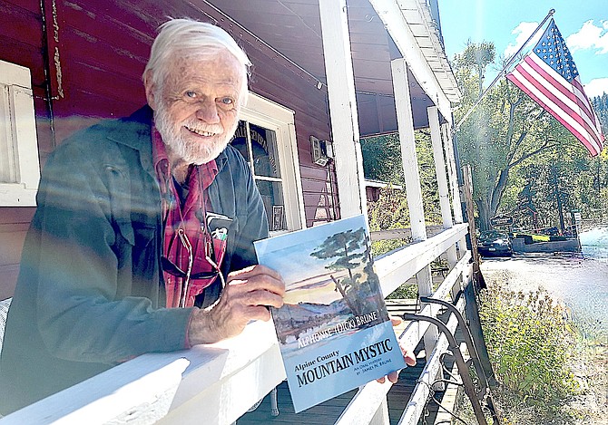Jim Brune with the book about his father Dick Brune in Markleeville.