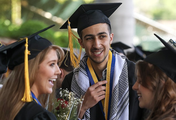 Eid Abdelhady celebrates with friends before the start of the Western Nevada College Commencement Ceremony on May 22, 2023, in Carson City.