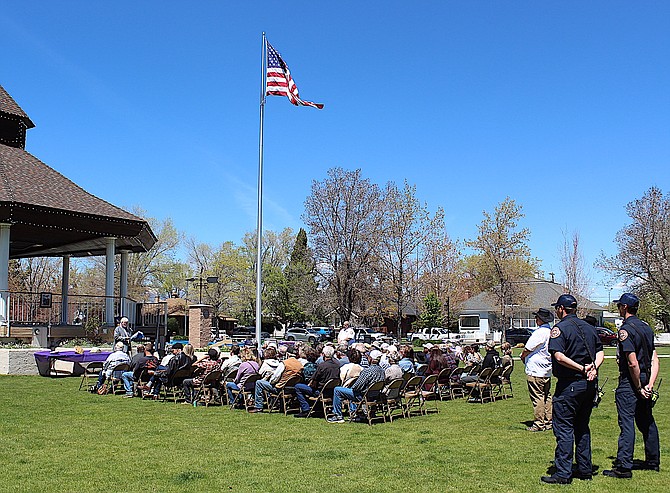 A gathering listens to Trinity Lutheran Church Elder Richard Thomas on Saturday.