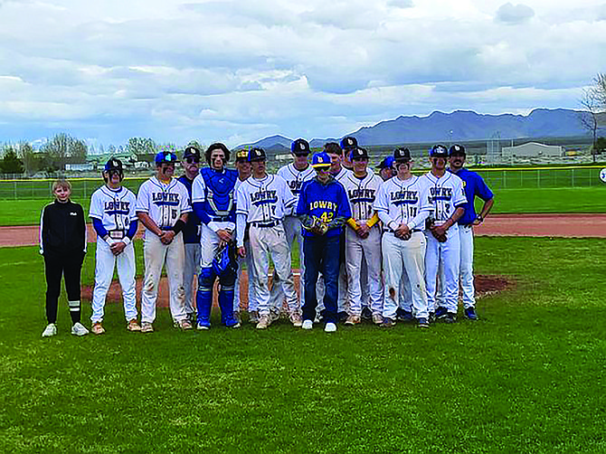 Joesph Esquibel with the Lowry High School baseball team after throwing his first pitch.