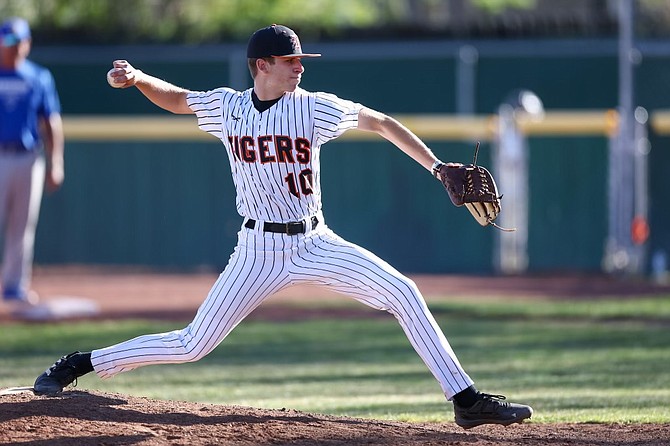 Douglas High senior Keegan Freeman delivers a pitch against Reed Tuesday. Freeman tossed five innings and struck out seven as the Tigers put themselves into a three-way tie for fourth place in Class 5A North league play with one game to go.