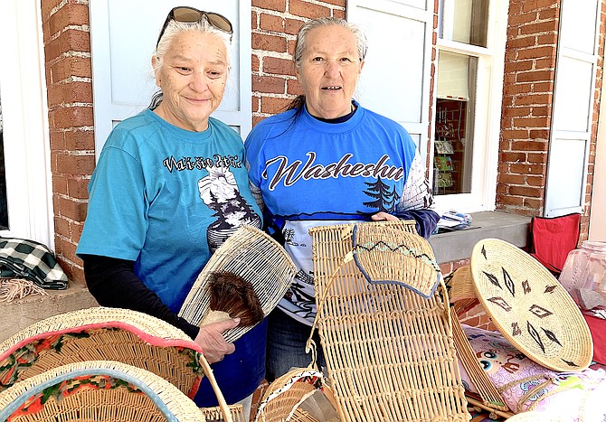 Darcy James, left, and her sister Judy display select items made with traditional basket making techniques from the collection of their parents, Adele and Alfred James.