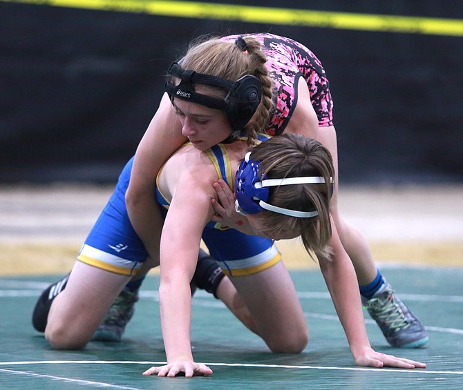Douglas High’s Ella Kavanagh wrestles an opponent from Lowry near the center 10-foot circle. That circle will be optional next season as the NFHS approved sweeping changes for the sport for the winter of 2024-25.