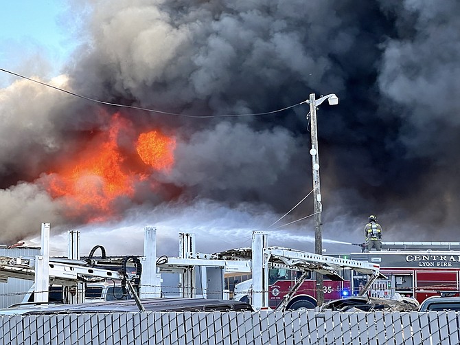 Firefighters from multiple agencies battled a blaze at a Mound House auto shop on Friday.