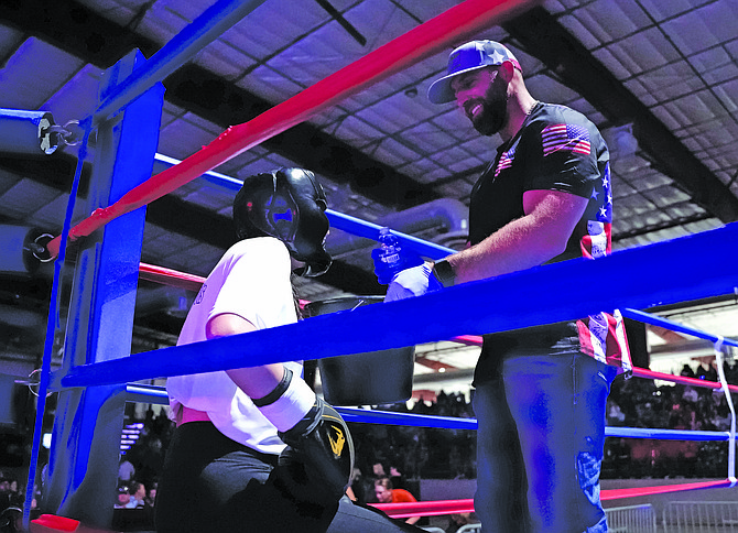 Trevor deBraga talks to Hailey Gupdraporne in the blue corner during Friday’s annual Night of Fights at the 3C Rafter Center.