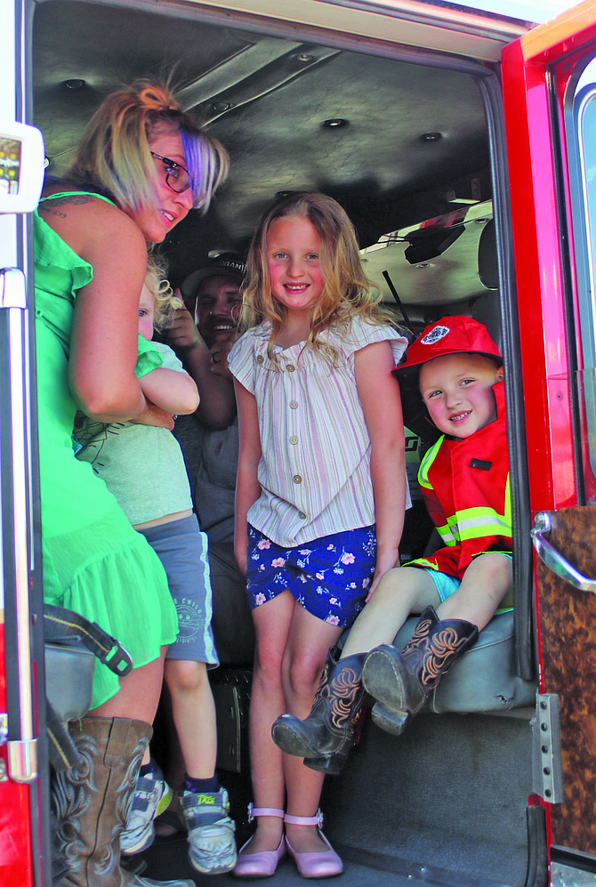 Youngsters (and mom) prepare to take a ride on the fire engine at a previous street dance.