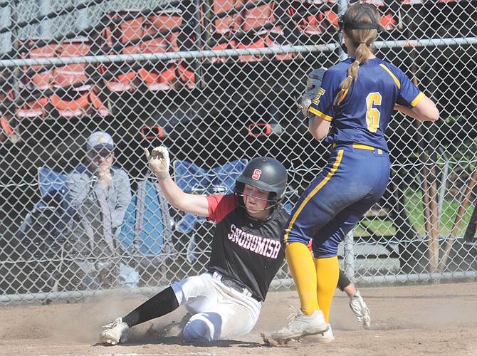 Snohomish Panther Avery Clark took advantage of a pass ball on a pitch to score a run as she slides across home plate while Everett Seagull pitcher Anna Luscher (6) tries to cover during action in Snohomish on Thursday. May 2. The Gulls struck early and held a lead into the late innings until the Panthers came back and tied the game up in the sixth. Neither team scored in the seventh which put the game into extra innings. A single by Emery Post in the bottom of the ninth allowed the winning run to score and gave the Panthers a 6-5 win. With the victory, the Panthers (15-5, 14-0 league as of Monday) clinched the Wesco 3A/2A title as they finished the regular season off in Monroe against the Bearcats (13-6, 11-3 league) on Monday, after press time. The Gulls (13-5, 10-3 league as of Monday) finished the regular season with games against Lynnwood and Edmonds-Woodway at the beginning of this week. Postseason action begins later this week with the District 1 3A tournament at Phil Johnson Fields in Everett. The Panthers pulled a bye in the tournament’s first round with the league title and will begin action in the quarter rounds on Tuesday, May 14.