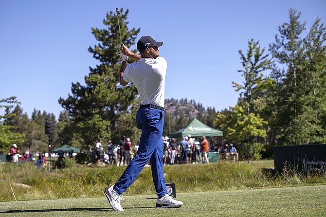 Stephen Curry watches a tee shot during last year’s American Century Championship at Edgewood Tahoe Golf Course.