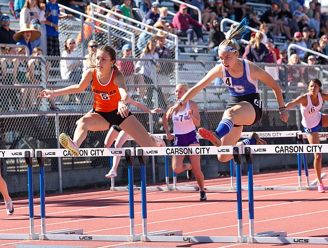 Carson High’s Anne Davis, right, clears the final hurdle in the 100-meter hurdles at the Class 5A North regional championship Friday at Carson High School. Davis qualified for state with a second place finish in 16.38.