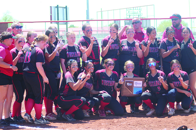 The 2024 Pershing County softball team displays their trophy.