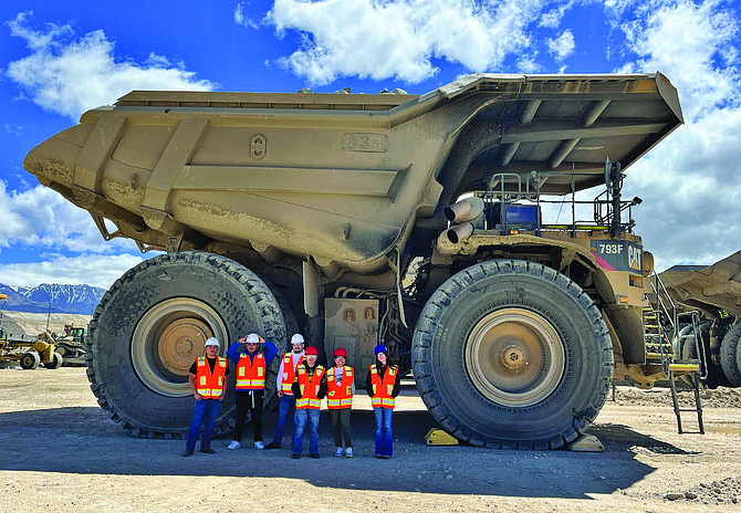 Jobs for Americas graduates stand in front of a CAT Haul Truck at Kinross Mining.