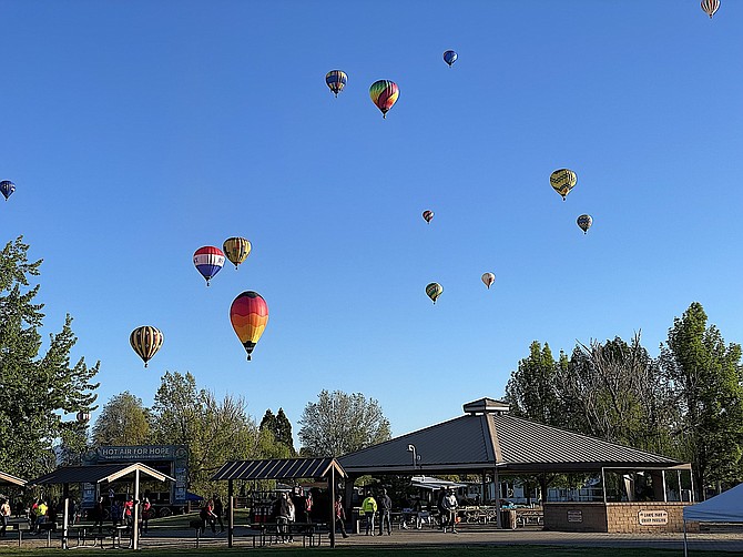 Hot-air balloons float over Lampe Park on Friday morning. Photo special to The R-C by Marilyn Smith