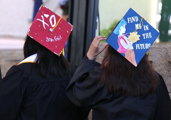 Graduates decorated their caps for Monday’s ceremony at Mills Park.