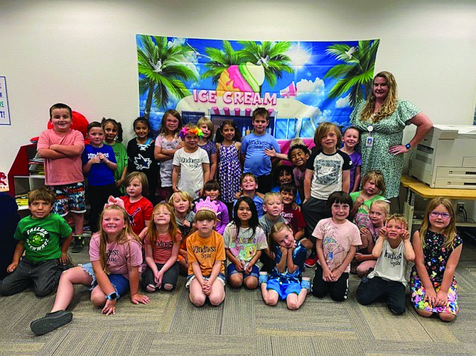 Theresa Moon and Shannon WindRiver’s Kindergarten Kindness Squad at Lahontan Elementary School pose with their librarian Megan Smith.