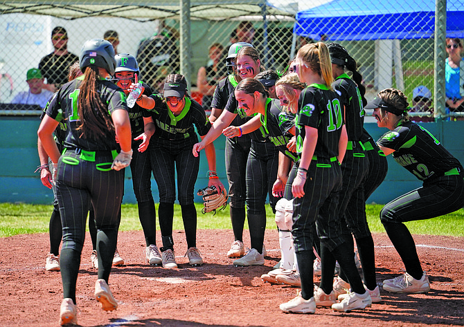 The Fallon softball team welcomes Janessa Bettencourt at the plate after her home run against Fernley on Saturday.