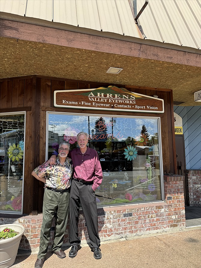 Richard Ahrens and Dr. Ed Denz stand for a photo outside Ahrens Valley Eyeworks in downtown 
Monroe in May. The shop began giving low-income patients from Project Access eye exams.