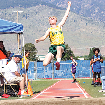 Battle Mountain's Blake Stuart goes airborne during an attempt in the long jump at the NIAA State Track and Field Championships in Carson City,