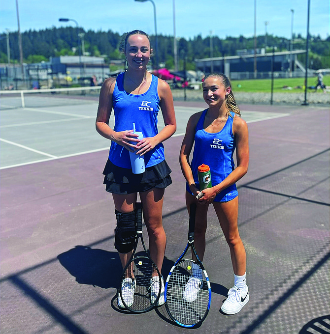 Eatonville's Alayna Meyer and Isabel Volk pose for a photo following their state-clinching victory at the Southwest Washington District 4 Tennis Playoffs