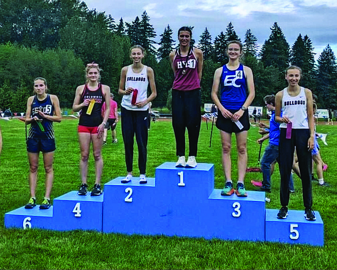 Eatonville's Grace Coonrod, who broke a 21-year-old school record, stands proudly on the podium after securing a 3rd place finish and a trip to the state meet.
