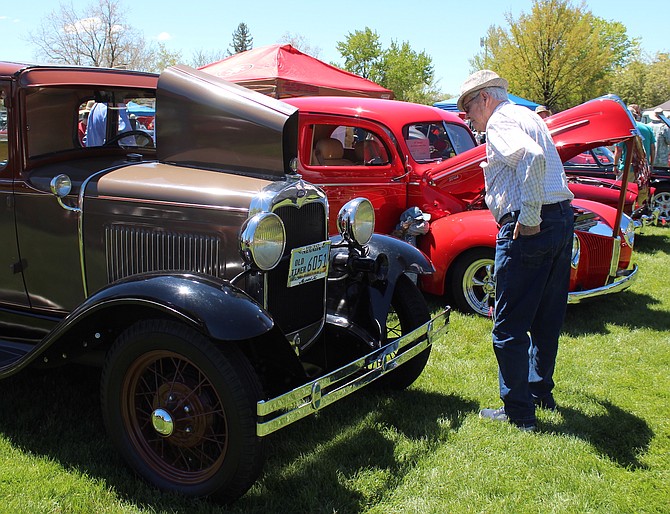 A visitor at Big Mama’s Show and Shine at Lampe Park on May 11 admires an Old Timer.