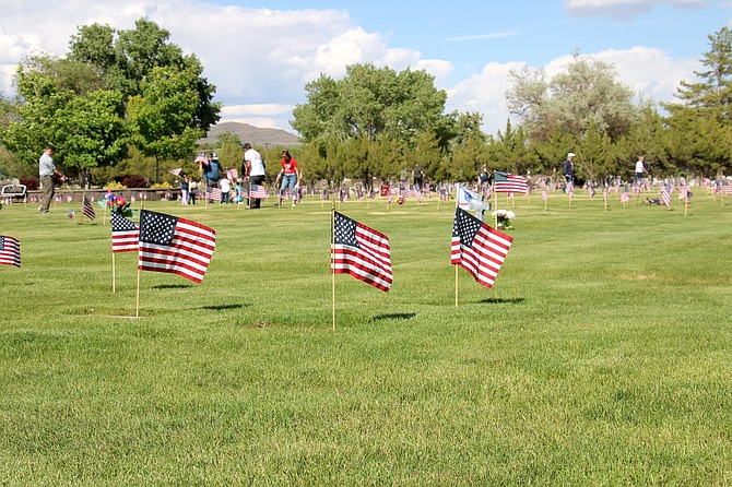 Flags flying for Memorial Day weekend on the central lawn of Lone Mountain Cemetery on Friday.