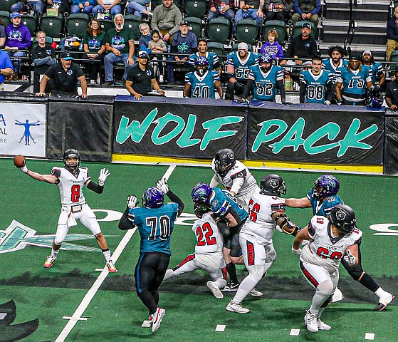 The Wolfpack prepare to sack Oregon’s quarterback during the May 18 game at Angel of the Winds Arena in Everett.