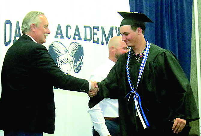 Mayor Ken Tedford congratulates Oasis graduate Andrew Catlin at the school’s commencement exercise May 23.