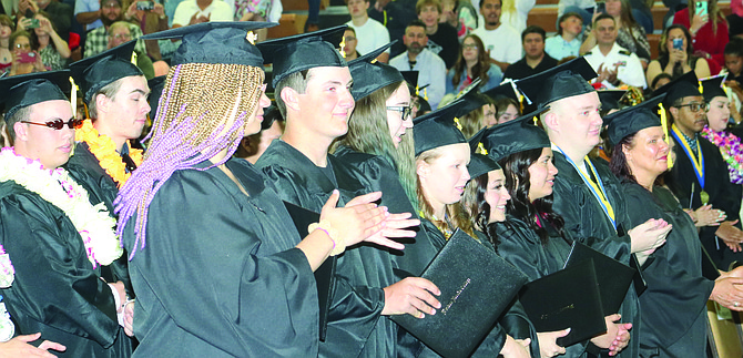 Western Nevada College Fallon graduates clap at the end of their commencement May 23 at the Fallon City-County Gym.