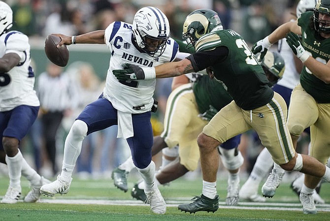 Nevada quarterback Brendon Lewis (2) tries to escape Colorado State linebacker Chase Wilson during the teams’ game last season.